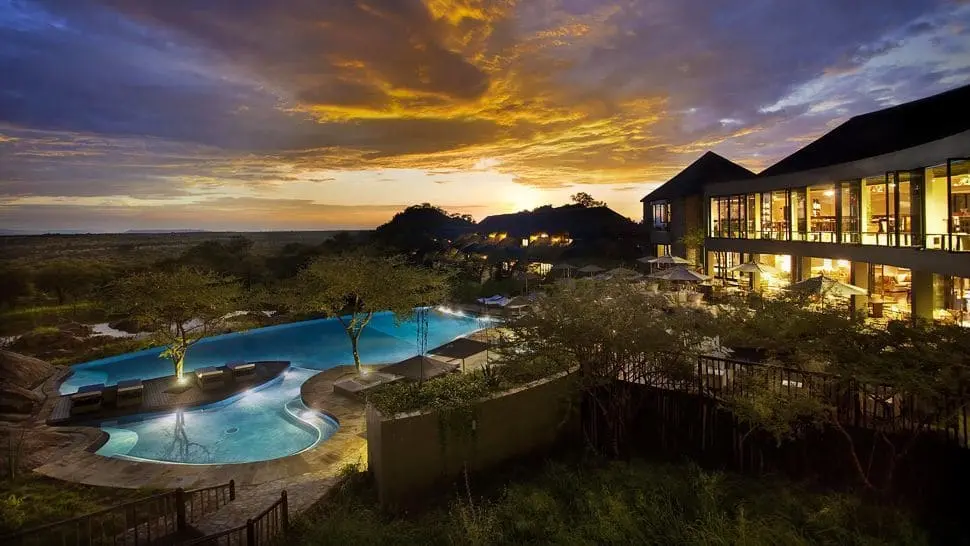 Serengeti lodge at sunset, with a pool and the captivating colors of the setting sun
